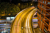 Highway with light trails at night; Kowloon, Hong Kong, China