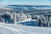 Skiiers outside a building at Sun Peaks Resort in the Rocky Mountains;  Sun Peaks, British Columbia, Canada