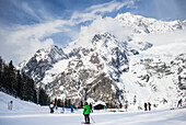 Skiers at an alpine resort, Italian side of Mont Blanc; Courmayeur, Aosta Valley, Italy