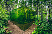 Art installation of green glass walls in a forest, Reford Gardens; Price, Quebec, Canada