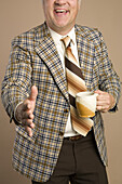 Retro Businessman With a Cup of Coffee Reaching for a Handshake