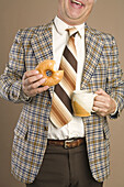 Retro Businessman Eating a Doughnut and Drinking a Cup of Coffee