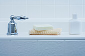 Bath Products on edge of Tub and Tap