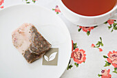 Overhead View of Used Tea Bag on Saucer with Cup of Tea, Studio Shot