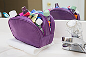 Women's Toiletry Travel Bag on Bathroom Counter filled with Personal Hygiene Products