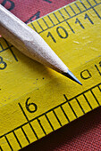 Close-up of sharpened pencil and wooden ruler