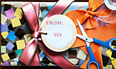 Wrapped present with scissors, tape and ribbon