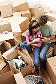 Couple Drinking Beer amongst Boxes