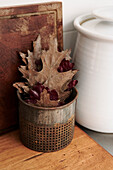 Leaf in Tin Can on Wooden Countertop