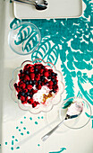 Overhead View of Berry Dessert in Glass Bowl with Spoons on Table with Tablecloth in Studio