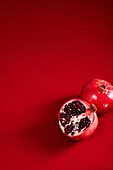 Cut Pomegranat on red background, studio shot