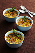 Savory brulee in small bowls with spoons, studio shot