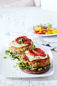 Quinoa veggie burgers on platter, studio shot