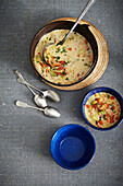 Smoked Trout Chowder in pot and bowls, studio shot