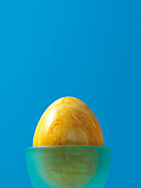 Yellow Easter Egg in Blue Eggcup