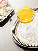 Glass of Advocaat on Serving Tray with Coin Purse, Studio Shot