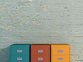 Digital Illustration of Three Filing Cabinets in a Row in front of Concrete Wall