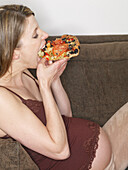 Pregnant Woman Eating Pizza