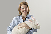 Veterinarian Holding Giant Rabbit