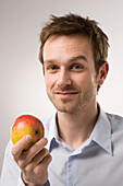 Portrait of Man Holding Apple