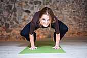 Woman in Yoga Class Doing Crow Pose