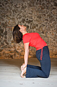 Woman in Yoga Class Doing Camel Pose