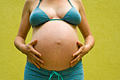 Woman, Nine Months Pregnant, Touching Her Belly