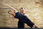 Woman Doing Pilates with Instructor