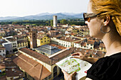 Woman Reading Map, Lucca, Lucca Province, Tuscany, Italy