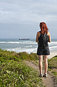 Backview of Woman Hiking and Looking at View, Ilha do Mel, Parana, Brazil