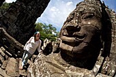 Tourist Outside Temple In Ancient City Of Angkor; Angkor Wat, Siem Reap, Cambodia