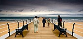 Family Of Four On Pier; Saltburn By The Sea, Yorkshire, England, Uk
