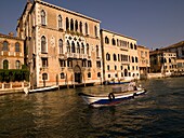 Mann fährt ein Motorboot; Canal Grande. Venedig, Italien