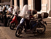 Motorcycles Parked In Front Of Old Building; Rome, Italy