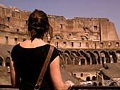 Tourist Standing In The Flavian Amphitheater (Colosseum); Rome, Italy