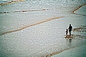Father And Son Walking On The Beach, Man Holding Fishing Rod; Sidmouth, Devon, England