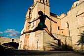 Woman Leaping In Old Town; Mexico