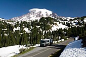 Caravan On Empty Road, Mt. Rainier In Background; Mt Rainier National Park, Washington State, Usa