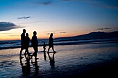 Puerto Vallarta, Mexico; People Walking Along Seashore At Sunset