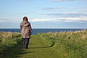 Woman Walking Path To Seashore, South Shields, Tyne And Wear, England