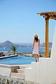 Woman On Terrace Of Resort, Cabo San Lucas, Mexico