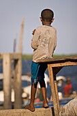 Young Boy Watching The Boats Come And Go, Lamu, Kenya, East Africa