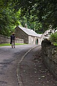 Woman Walking Up Country Road, Ford And Etal, Northumberland, England
