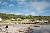 Woman Flying A Kite On Beach, Island Of Arran, Scotland