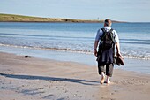 Man Walking On The Beach; Northumberland, England