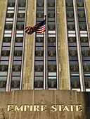 U.S. Flag In Front Of Empire State Building, Manhattan, New York, Usa