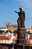 Statue On Charles Bridge With Hradcany In Background