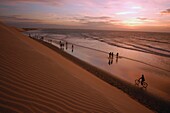 People In Silhouette Walking By Dunes, High Angle View