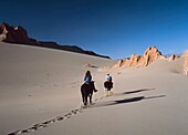 Two People Horse Riding In Valle De La Muerte