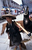 Cormorants And Fisherman Posing For Tourists